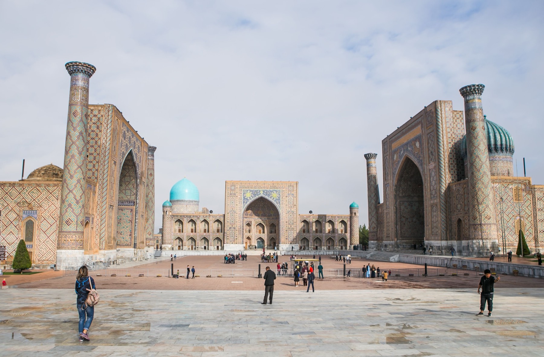 The Registan in Samarkand, its three tiled madrasahs facing the open square under a wide sky.